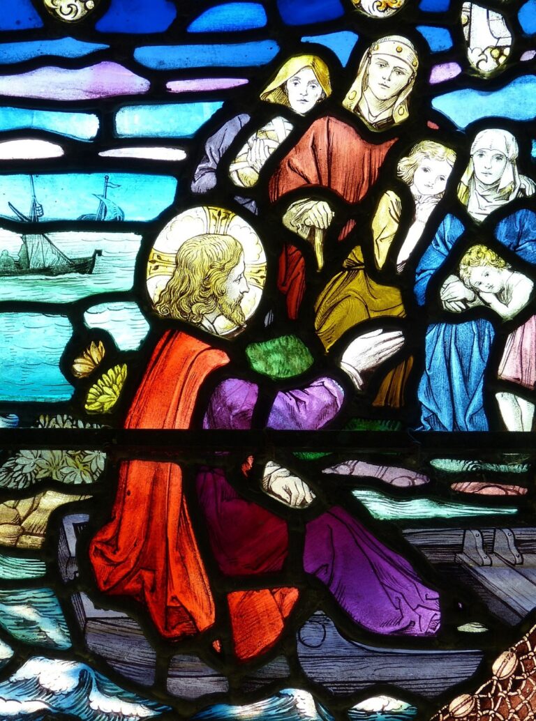 A stained-glass image of Jesus, in a boat, speaking to people